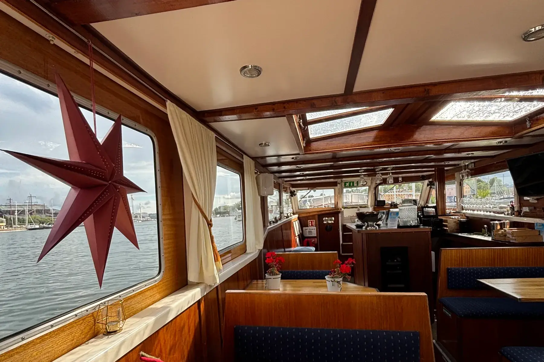 The cabin of the closed boat, with a star in the window and tables set