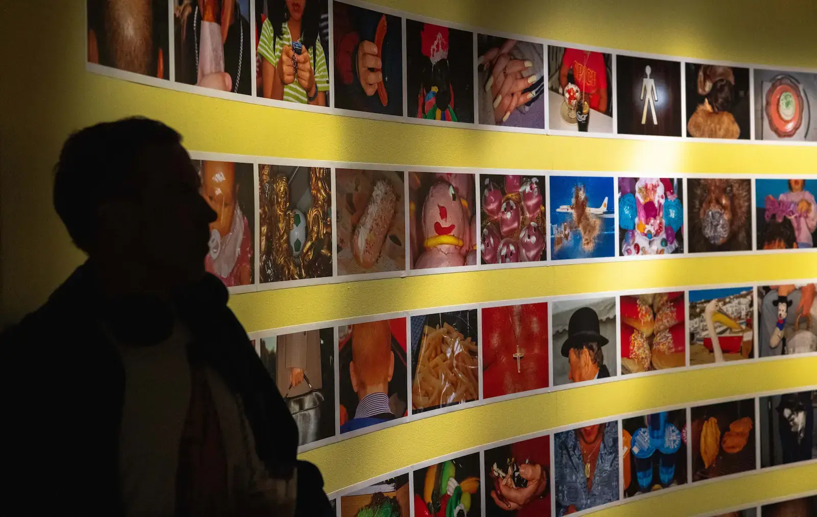 Visitor in front of a colourful photography exhibition at Fotografiska Stockholm