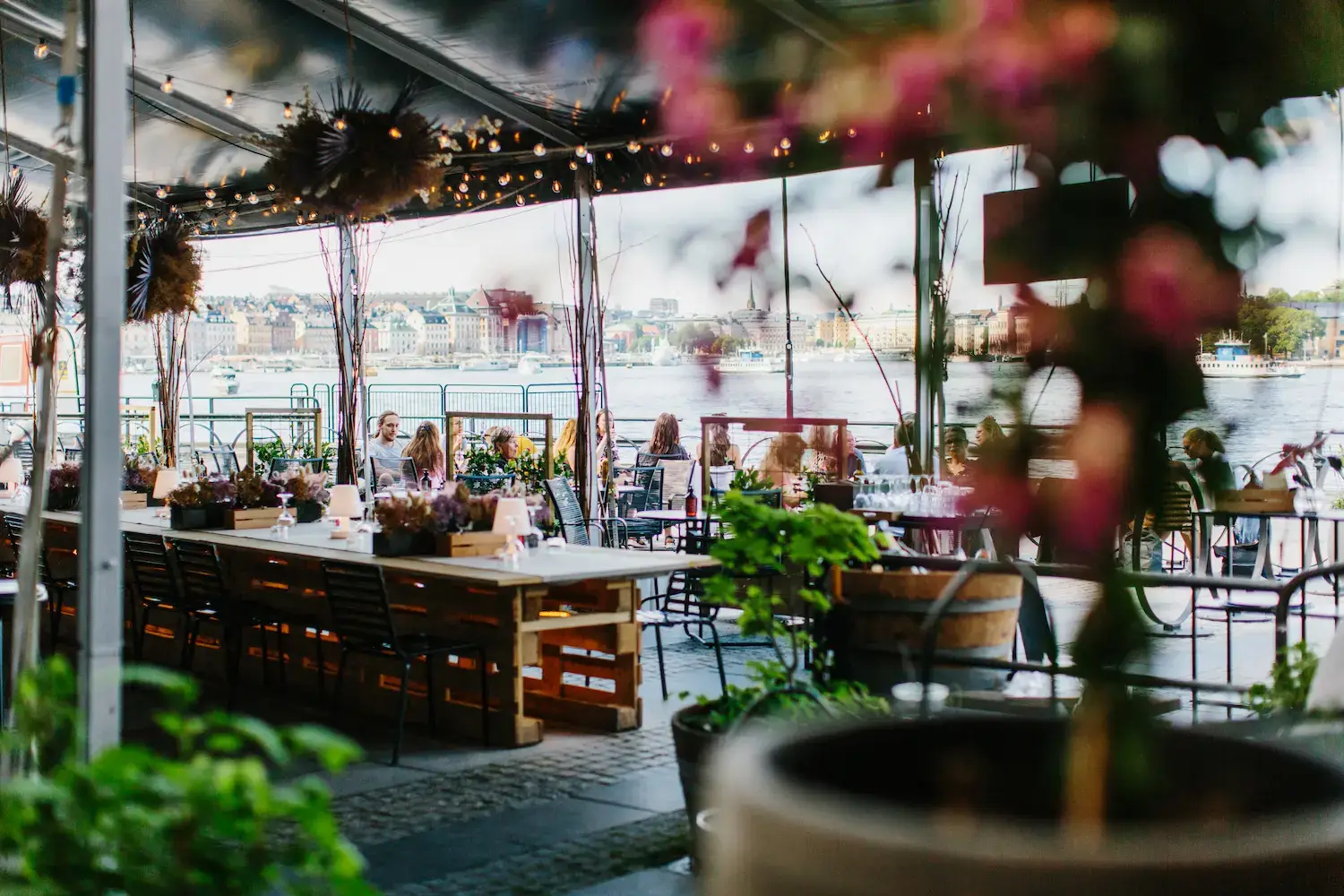 Outdoor terrace at Fotografiska's restaurant overlooking Stockholm's water and the Old Town