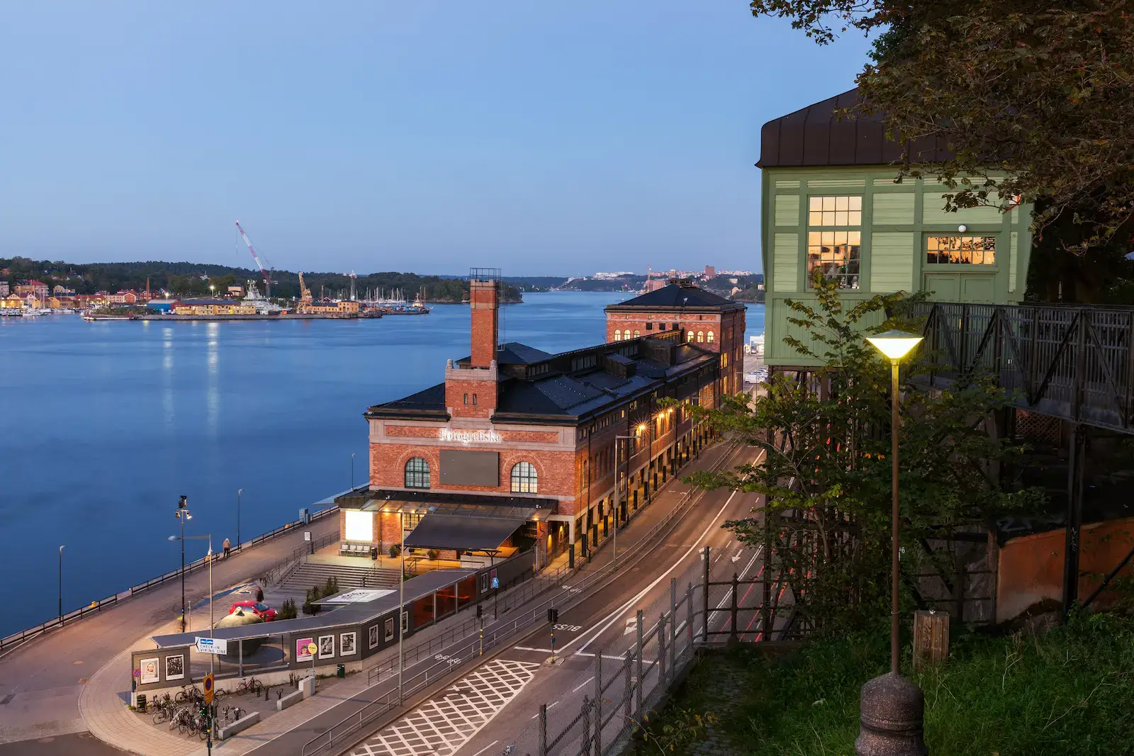 Fotografiska on the Stockholm waterfront at dusk, seen from above