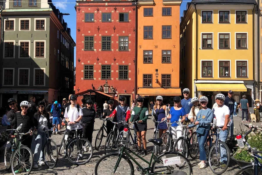 Guided bike tour group with bicycles at Stortorget in Gamla Stan